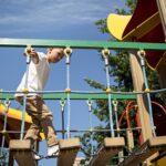 young-boy-having-fun-outdoors-playground-min